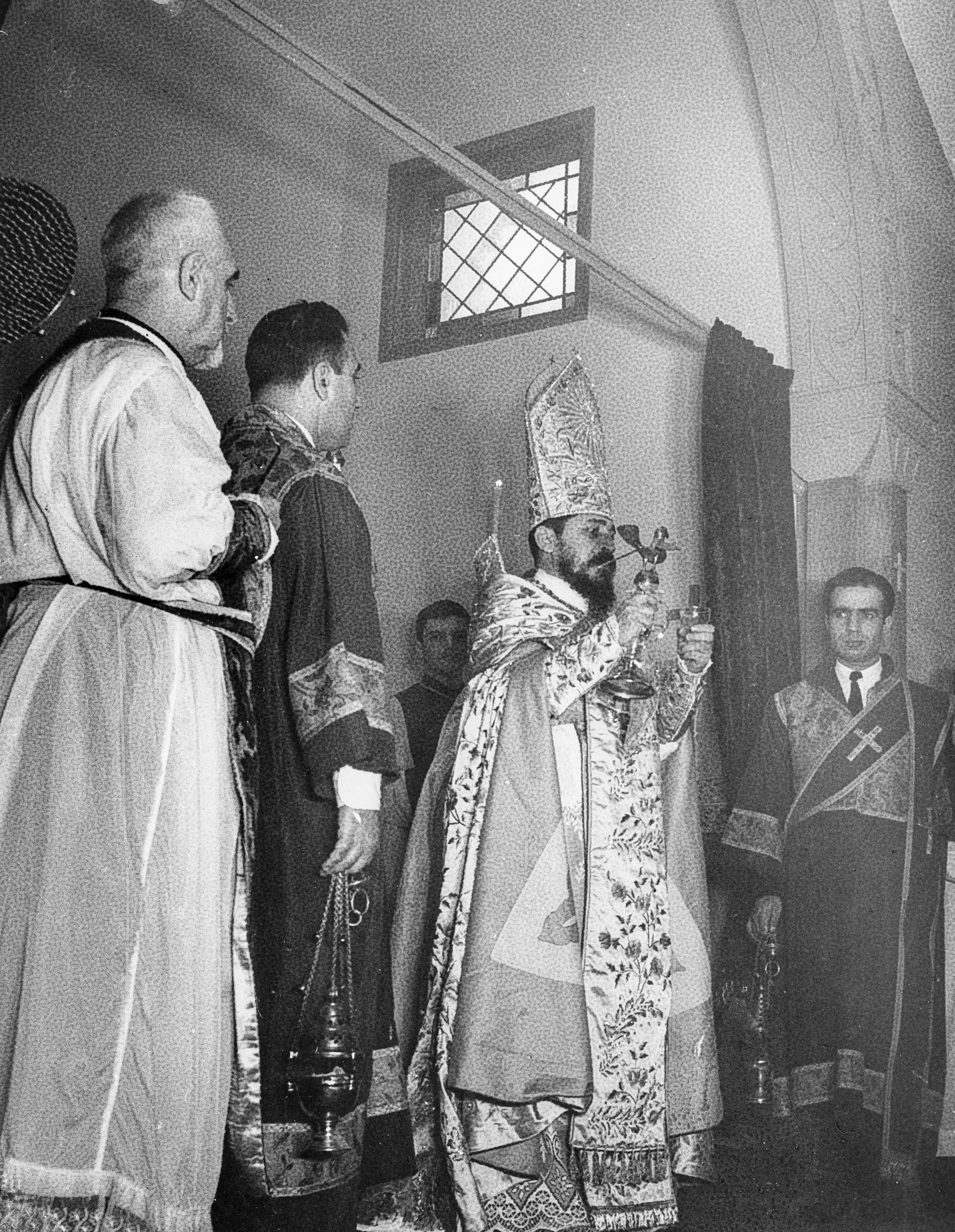Archbishop Khoren Paroian holding the silver dove containing holy chrism during the church's consecration ceremony, November 24, 1957.
